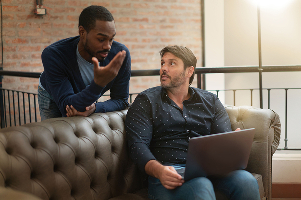Two men discussing information.
